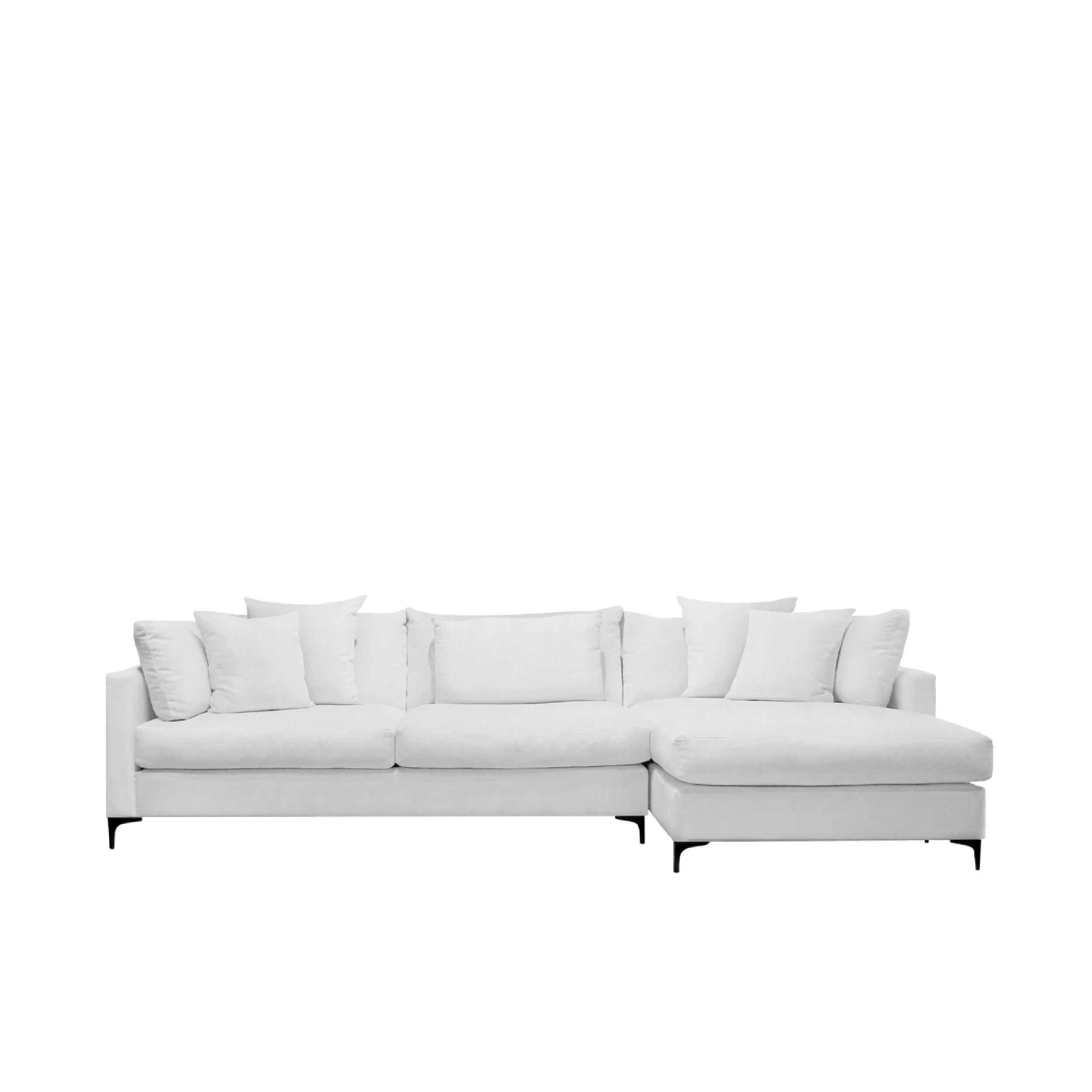 A white sectional sofa with sleek metal legs and a minimalist design, featuring cushions with a similar fabric to the body.
