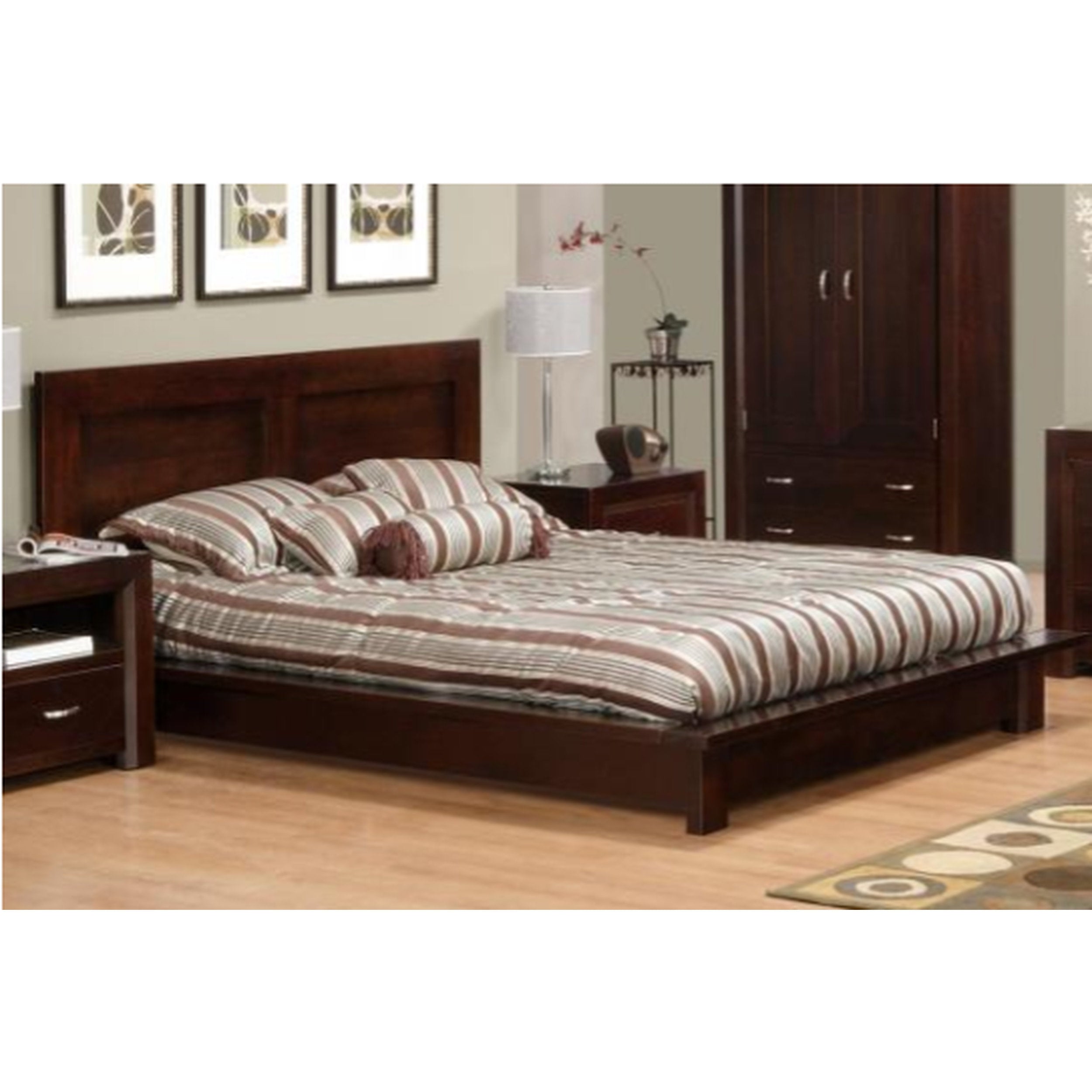 Wooden bed with striped bedding in a bedroom setting