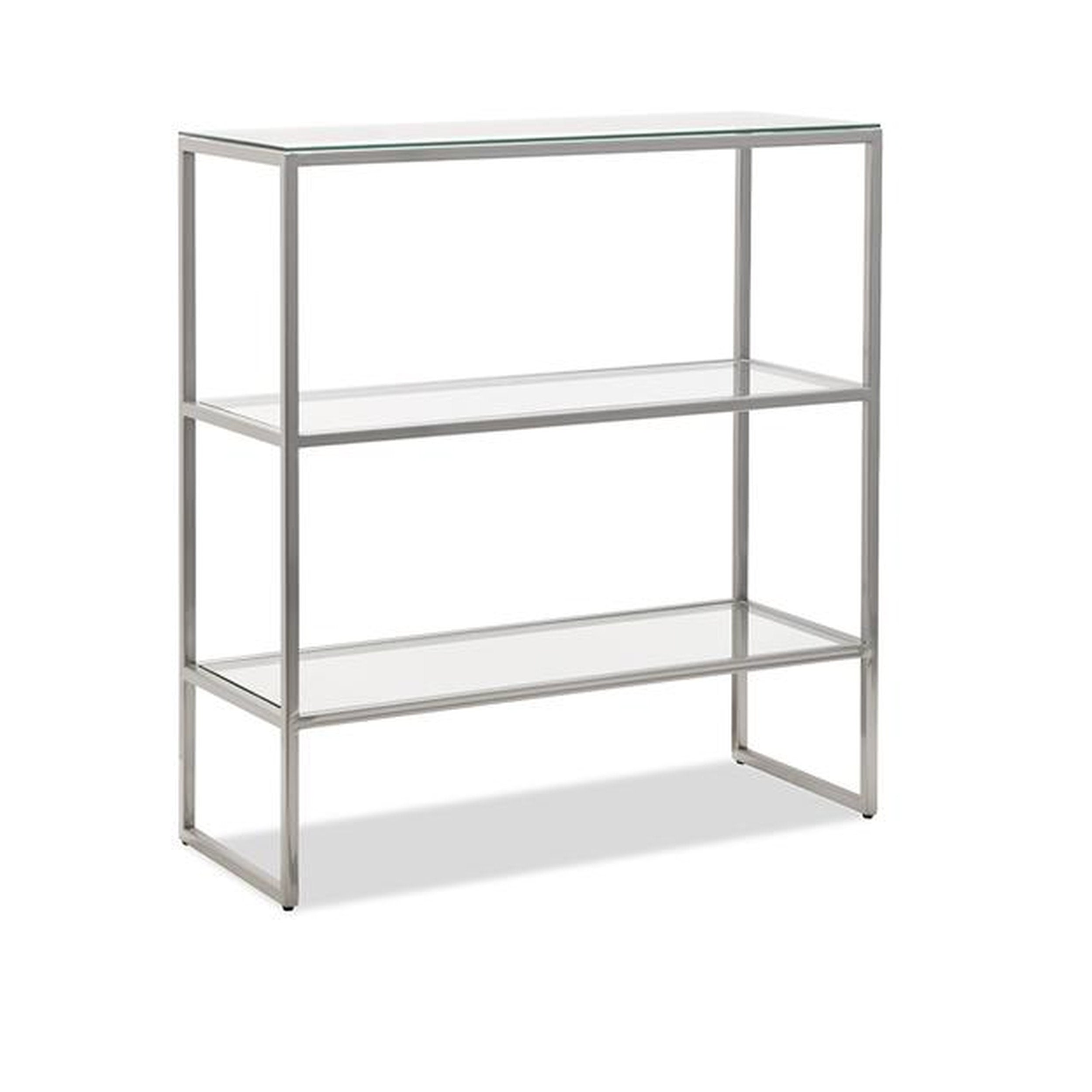 Three-tier metal shelf with glass shelves on a white background