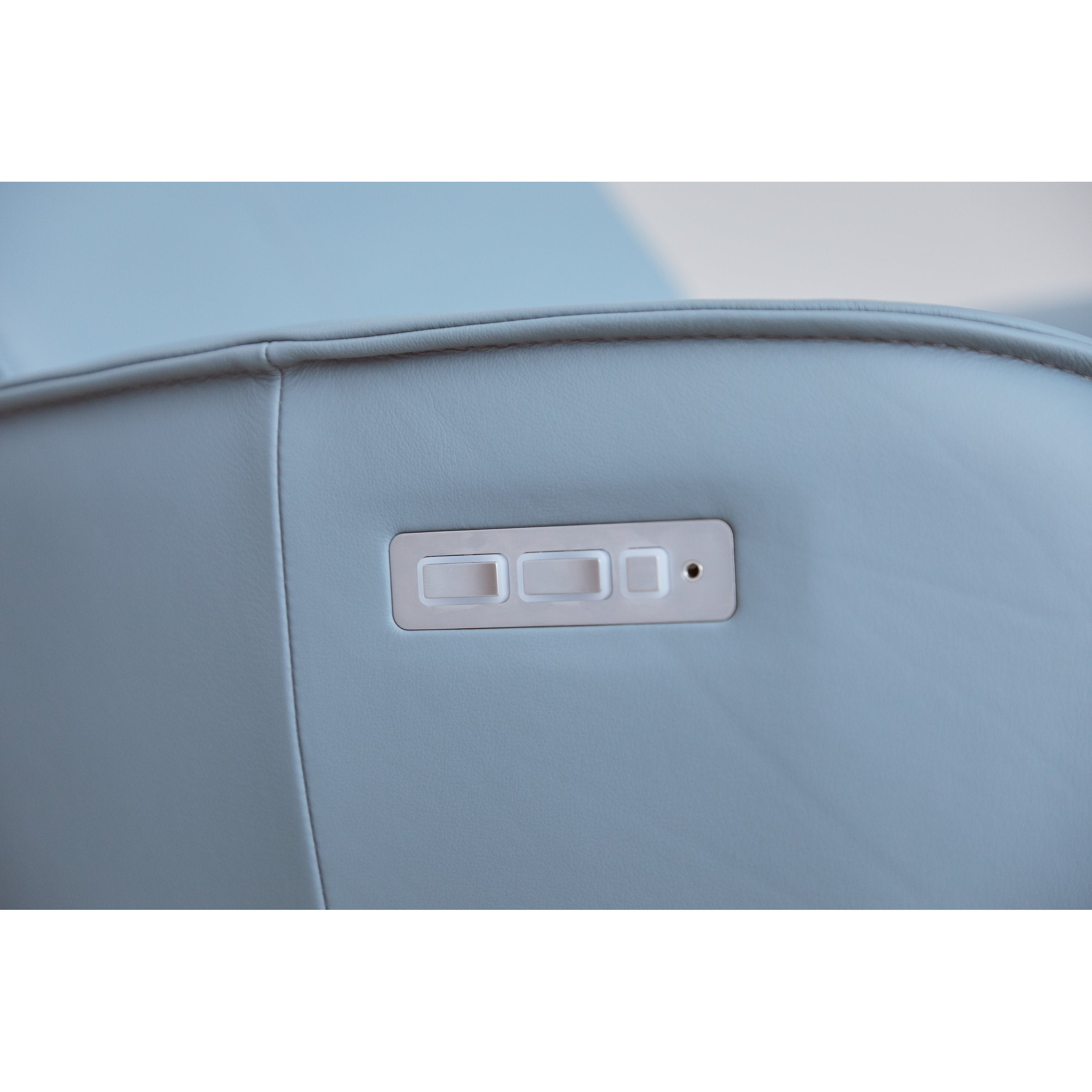 Close-up of a light blue seat with a control panel.