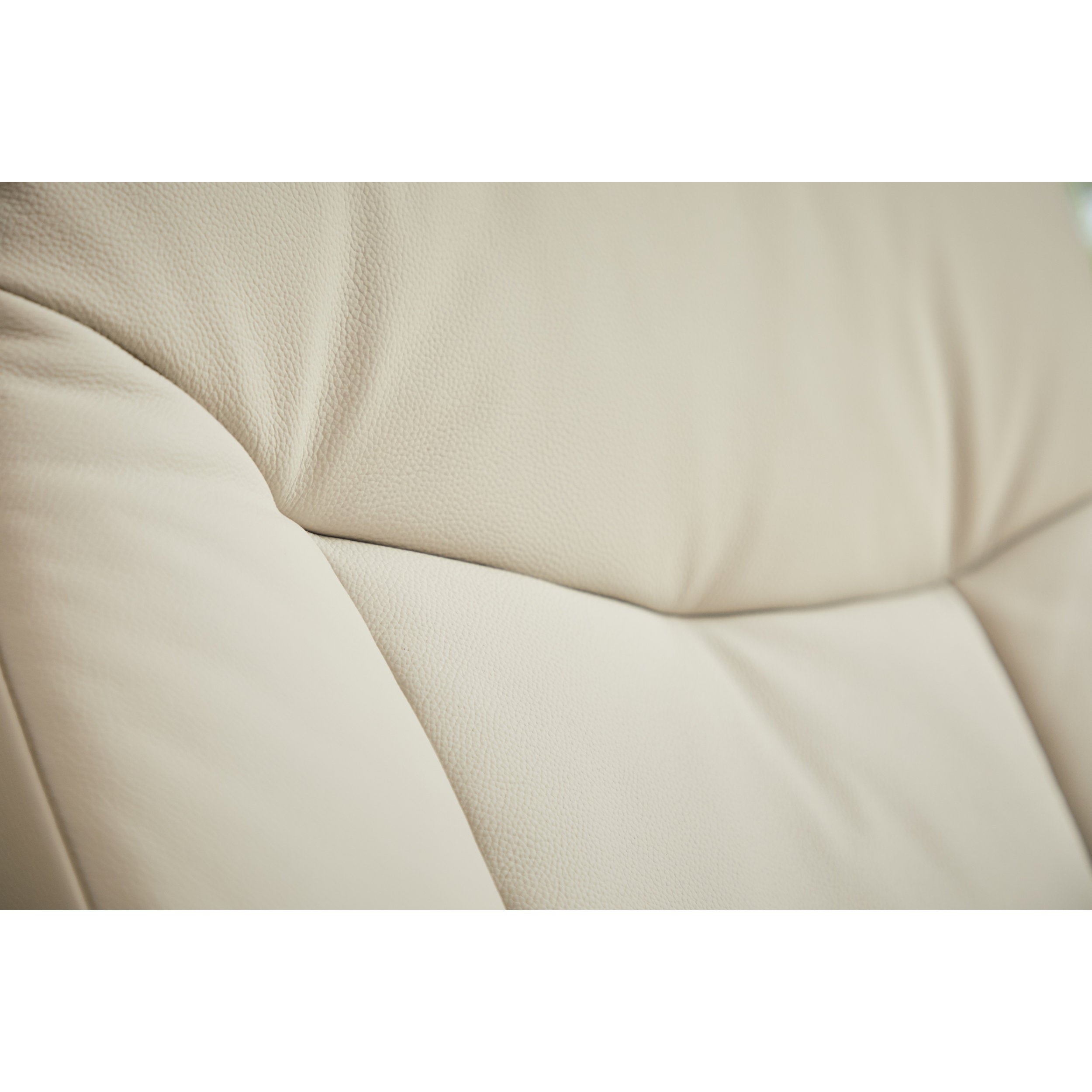 Close-up of beige leather upholstery with a subtle texture.