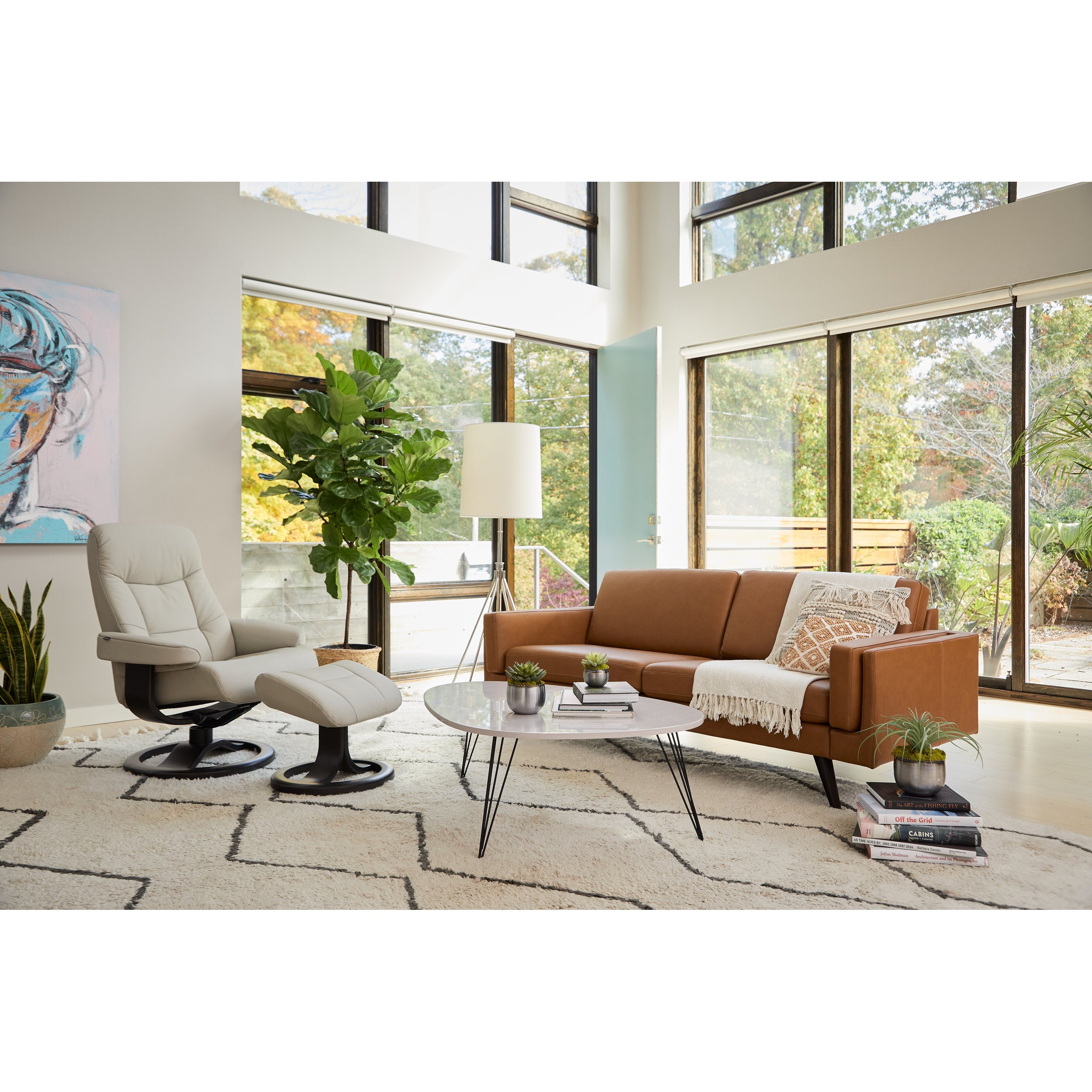 Modern living room with a brown sofa, white armchair, and coffee table.