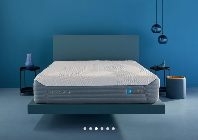 white mattress on a blue bed frame.