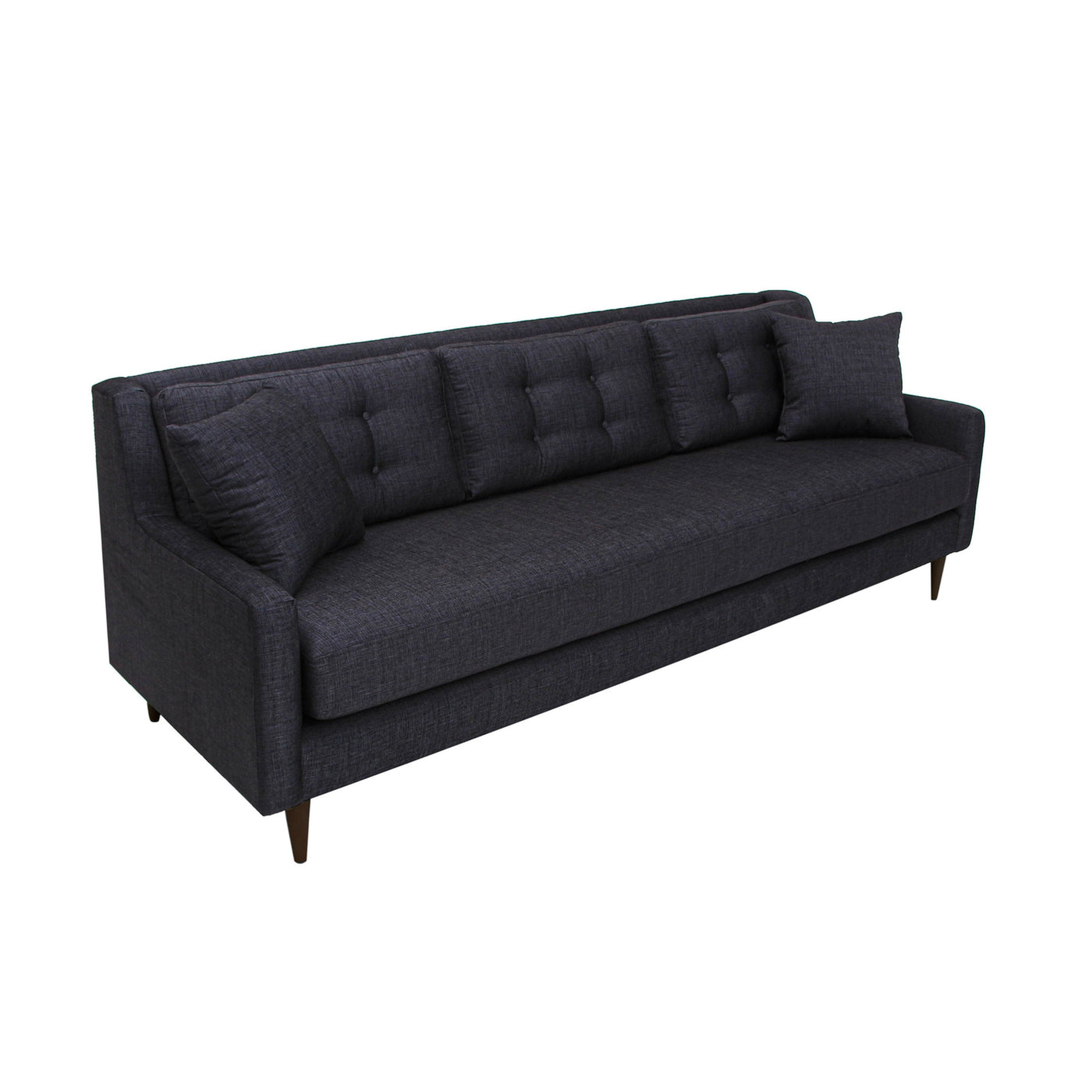 Dark gray sofa with buttoned backrest on a white background