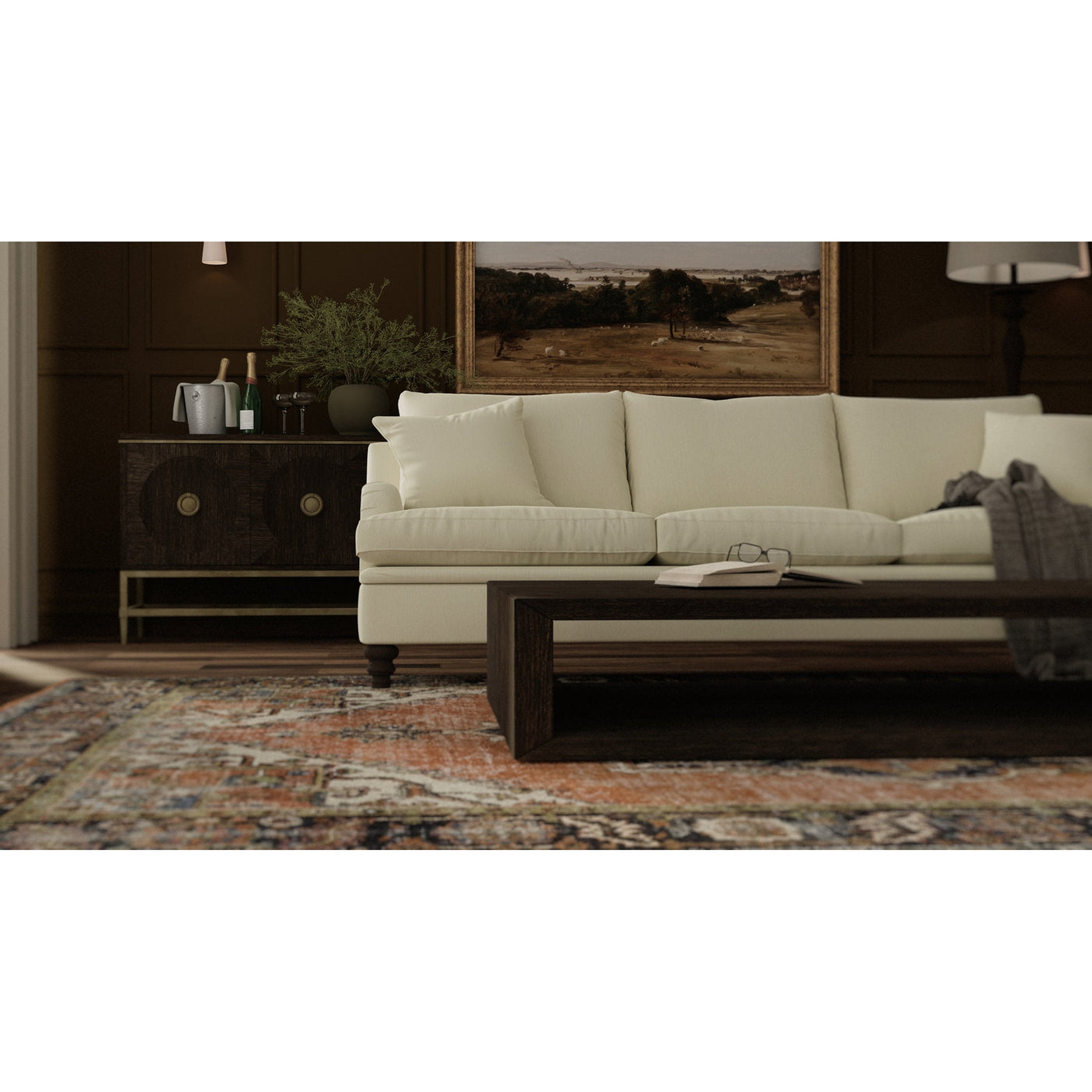 Beige sofa in a living room setting with a rug and decorative items.