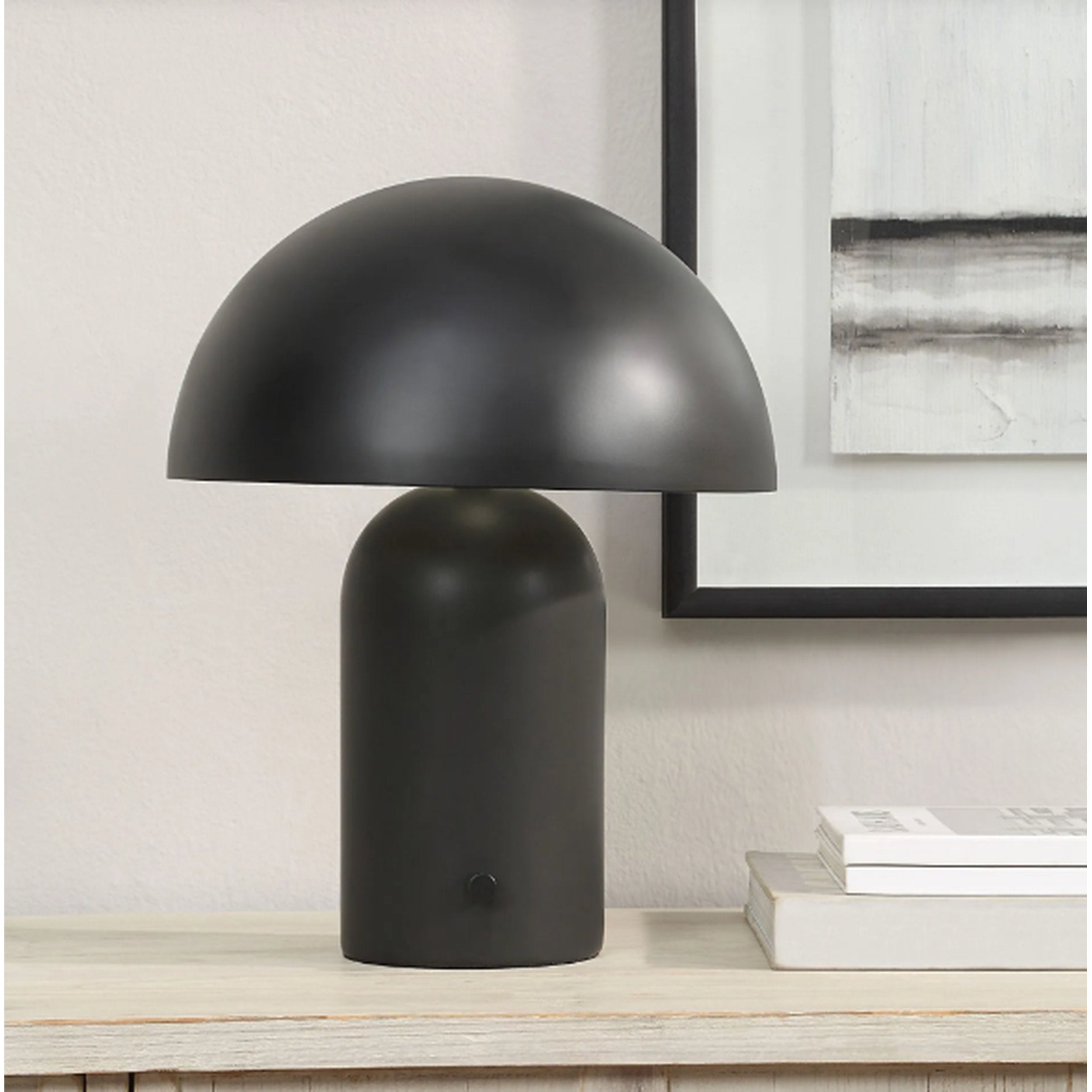 Black table lamp on a wooden surface with a neutral background