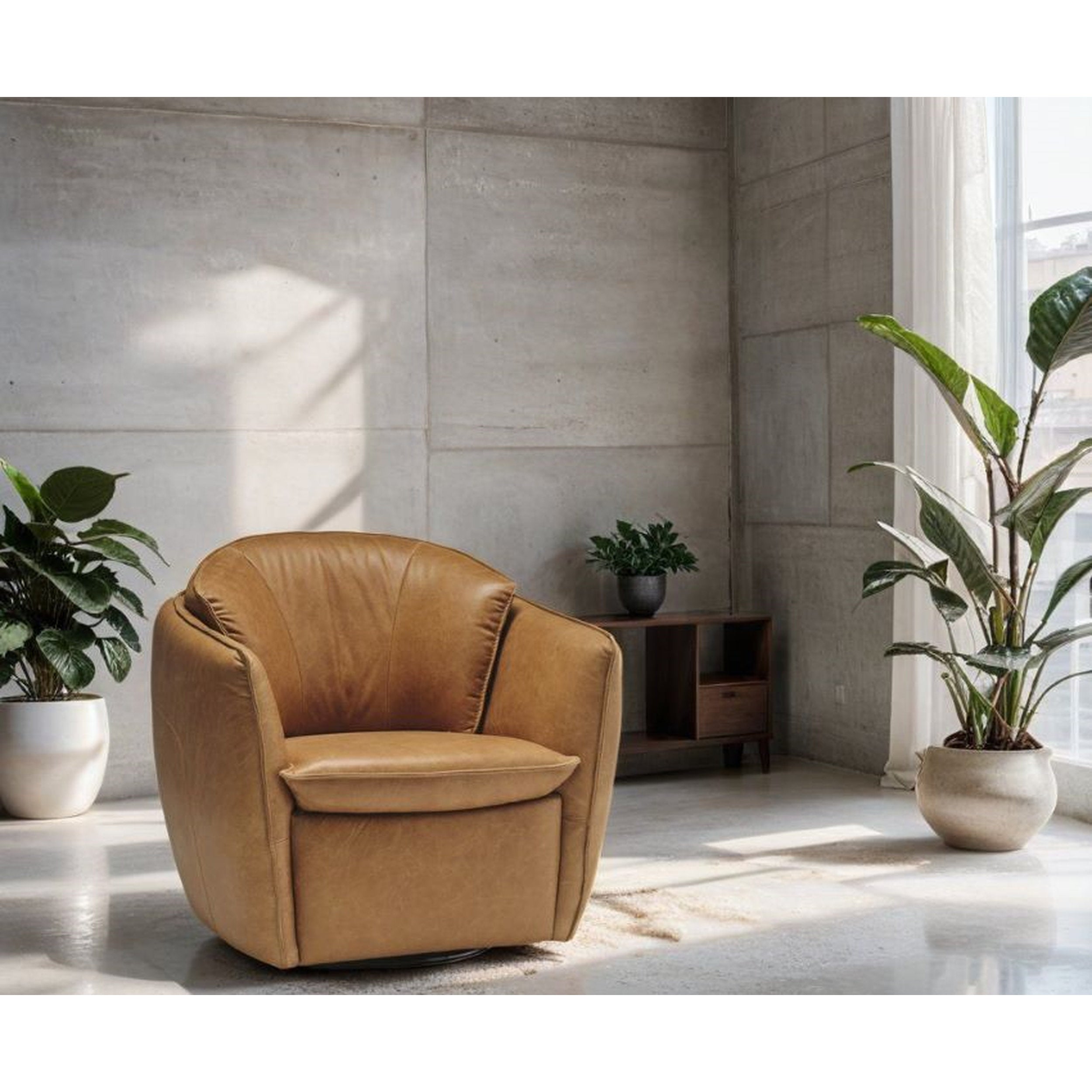 Sola Swivel Chair by Stylus in warm tan leather, rounded cushions, metal swivel base, modern living room with plants accents