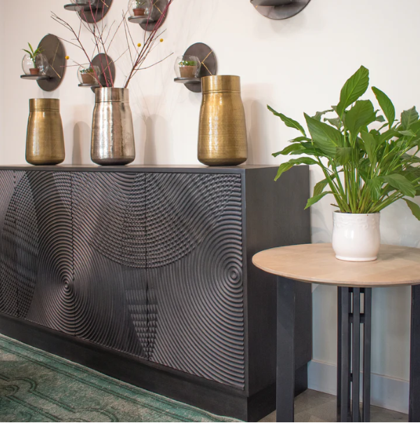 spiral sideboard on display along a off white room and a close up on the spiral pattern