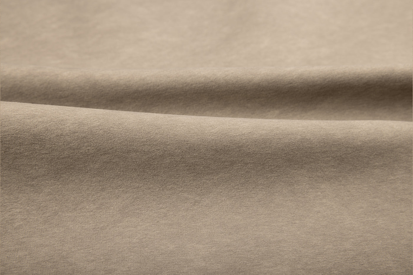 Stewart Putty by Van Gogh Designs in warm tan suede fabric, soft beige texture with smooth folds and subtle tonal depth.
