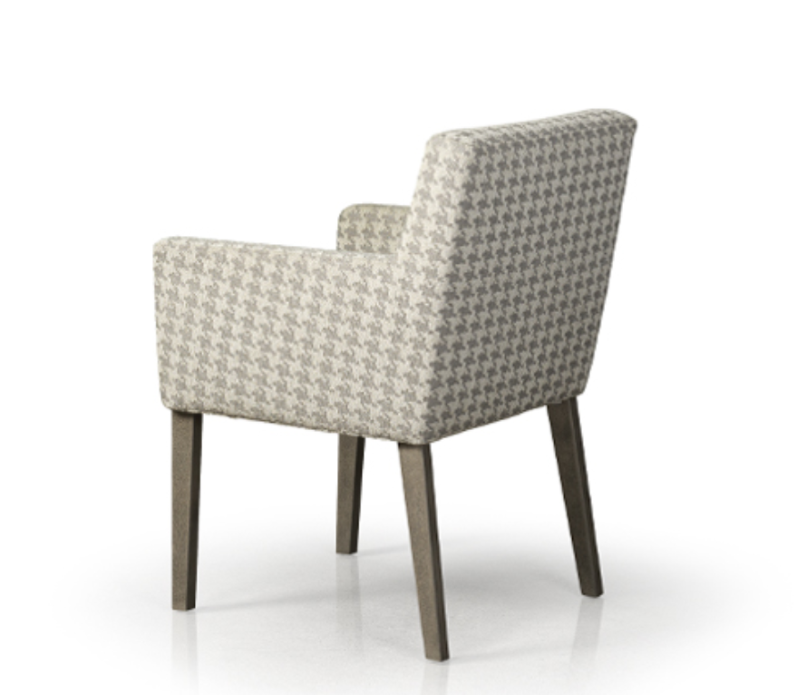 A modern upholstered dining chair with a high backrest and seat, featuring a geometric pattern on the seat and a solid wood leg.