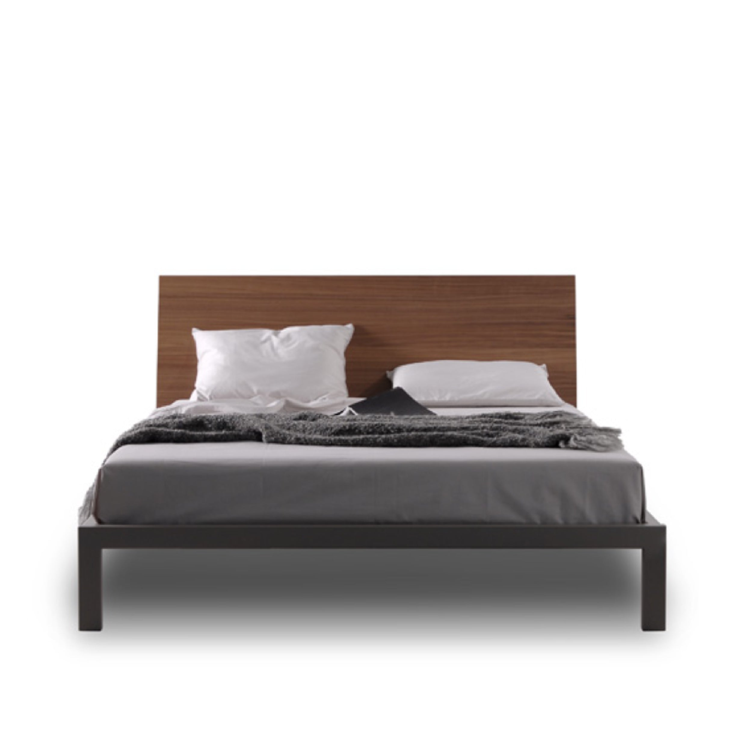 A modern platform bed with a dark gray metal frame and a wooden headboard, dressed with white and black bedding.