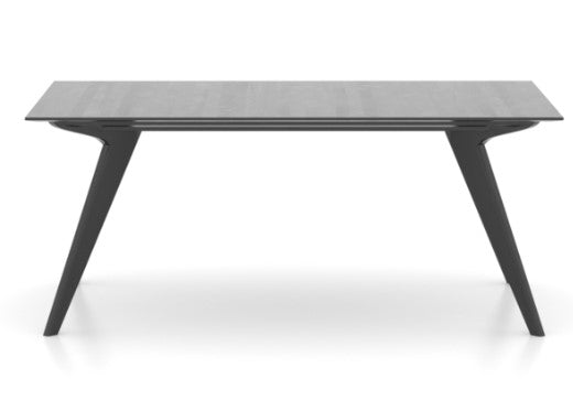 A modern, minimalist Scandinavian style rectangular wood top table with dark gray legs.