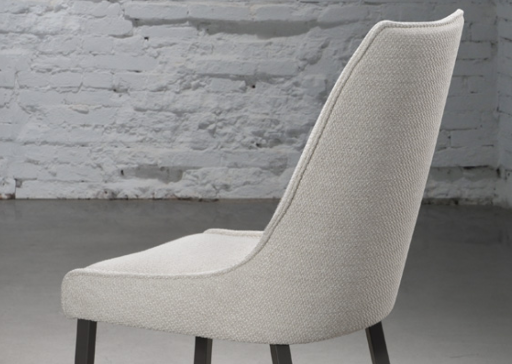 A modern dining chair with a fully welded metal frame and a cushioned seat and backrest upholstered in a solid color fabric.