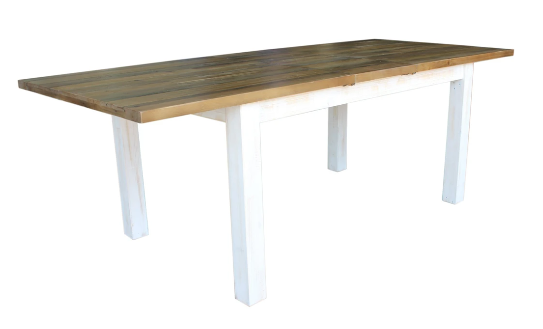 A rectangular dining table with a natural finished top and an antique white finished base.