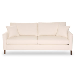 Beige sofa with wooden legs on a white background