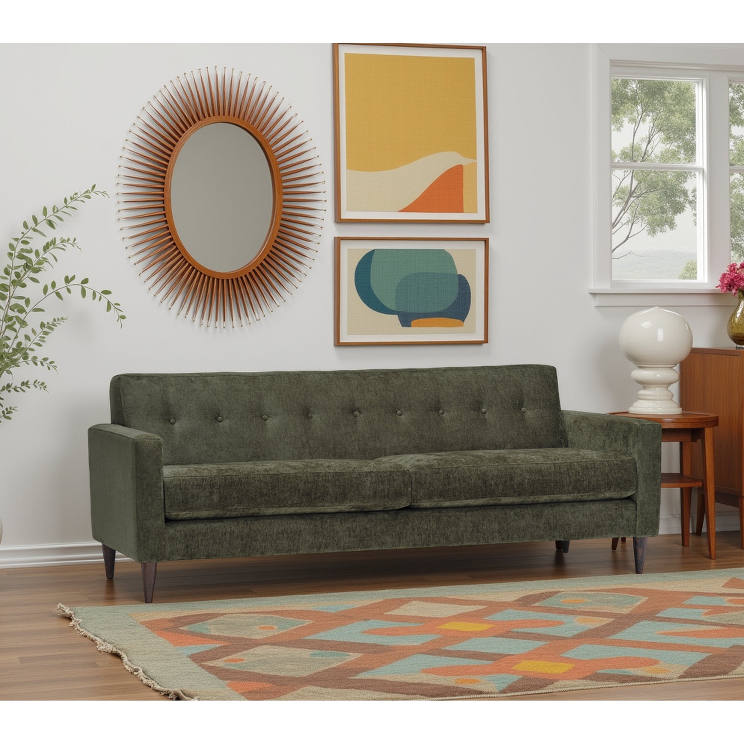 Green sofa in a living room with wall art and decor