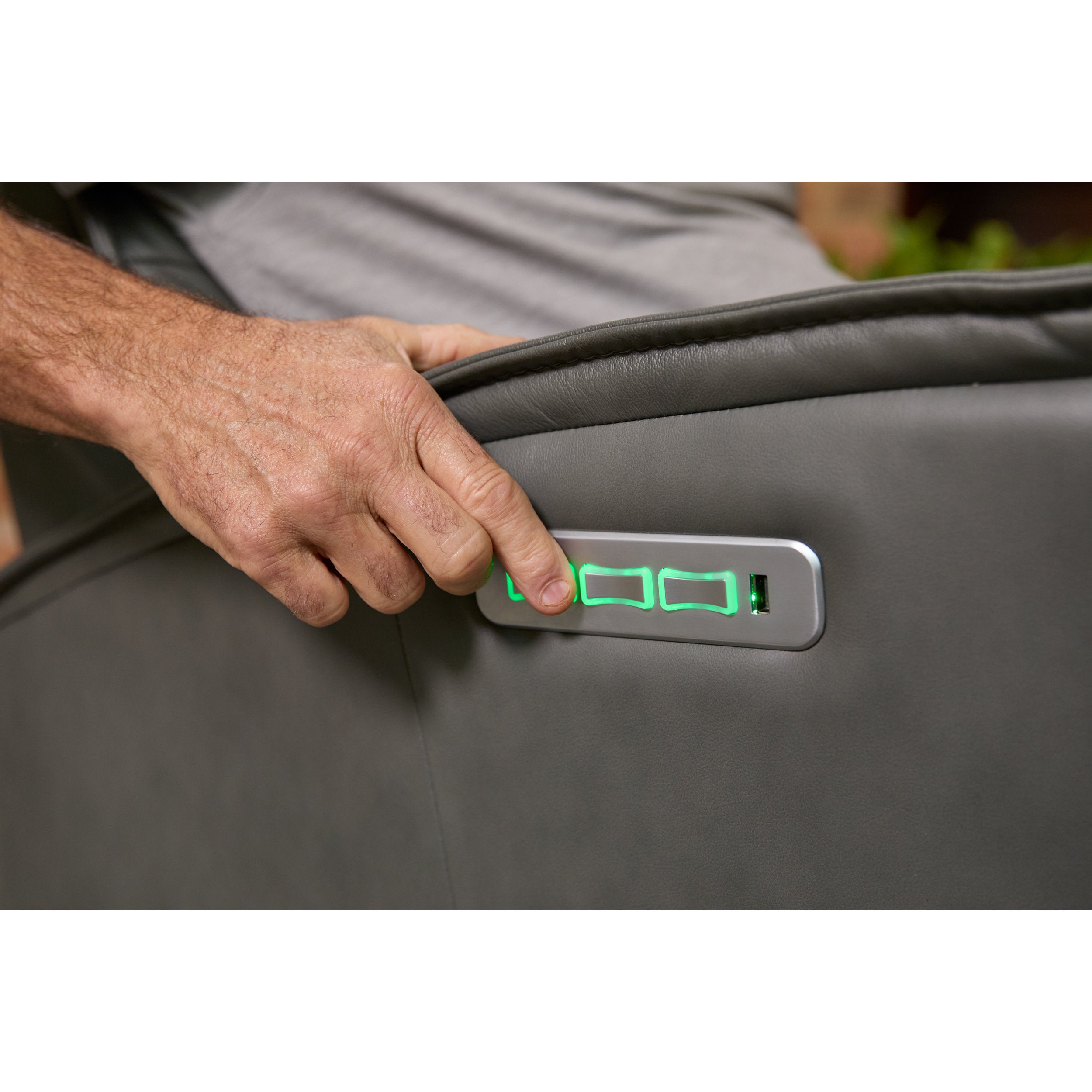 Hand opening a gray control panel for chair