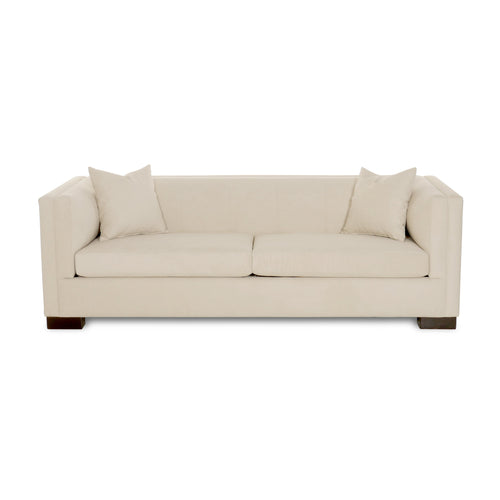 Beige sofa with two cushions on a white background