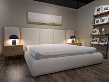 Load image into Gallery viewer, Bedroom setting with a large bed and nightstands in a room.

