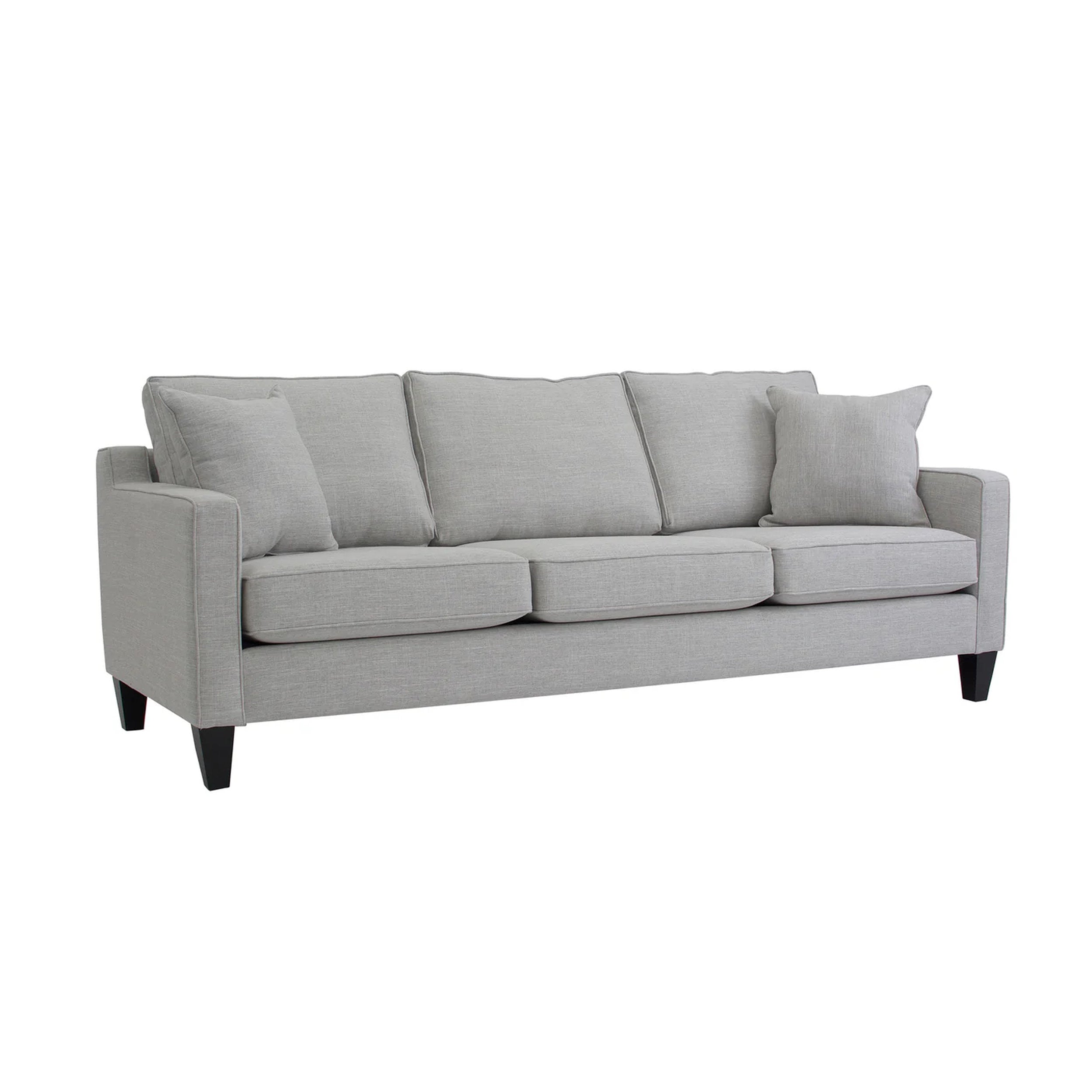 Gray sofa with four cushions on a white background