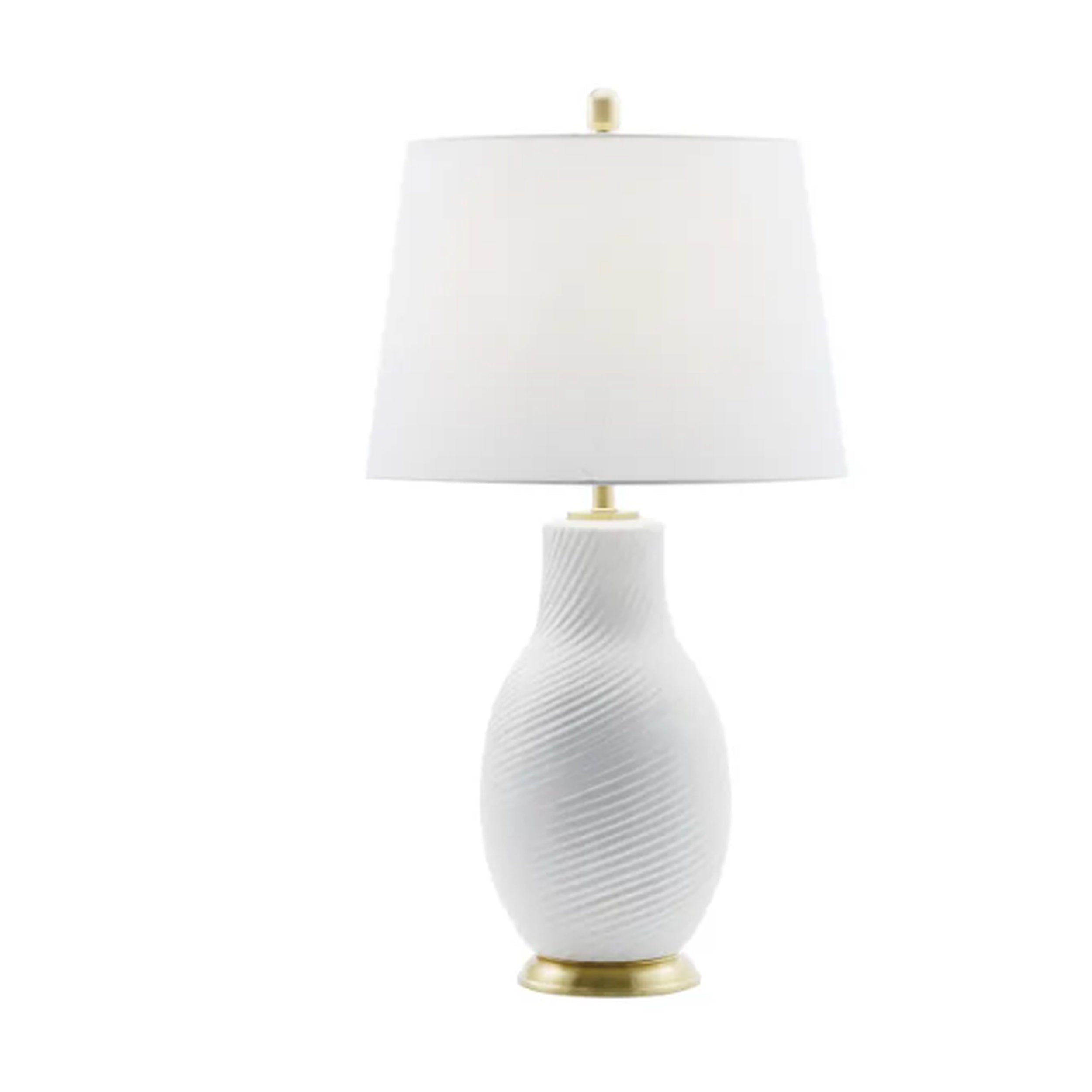 White textured table lamp with a white shade on a white background