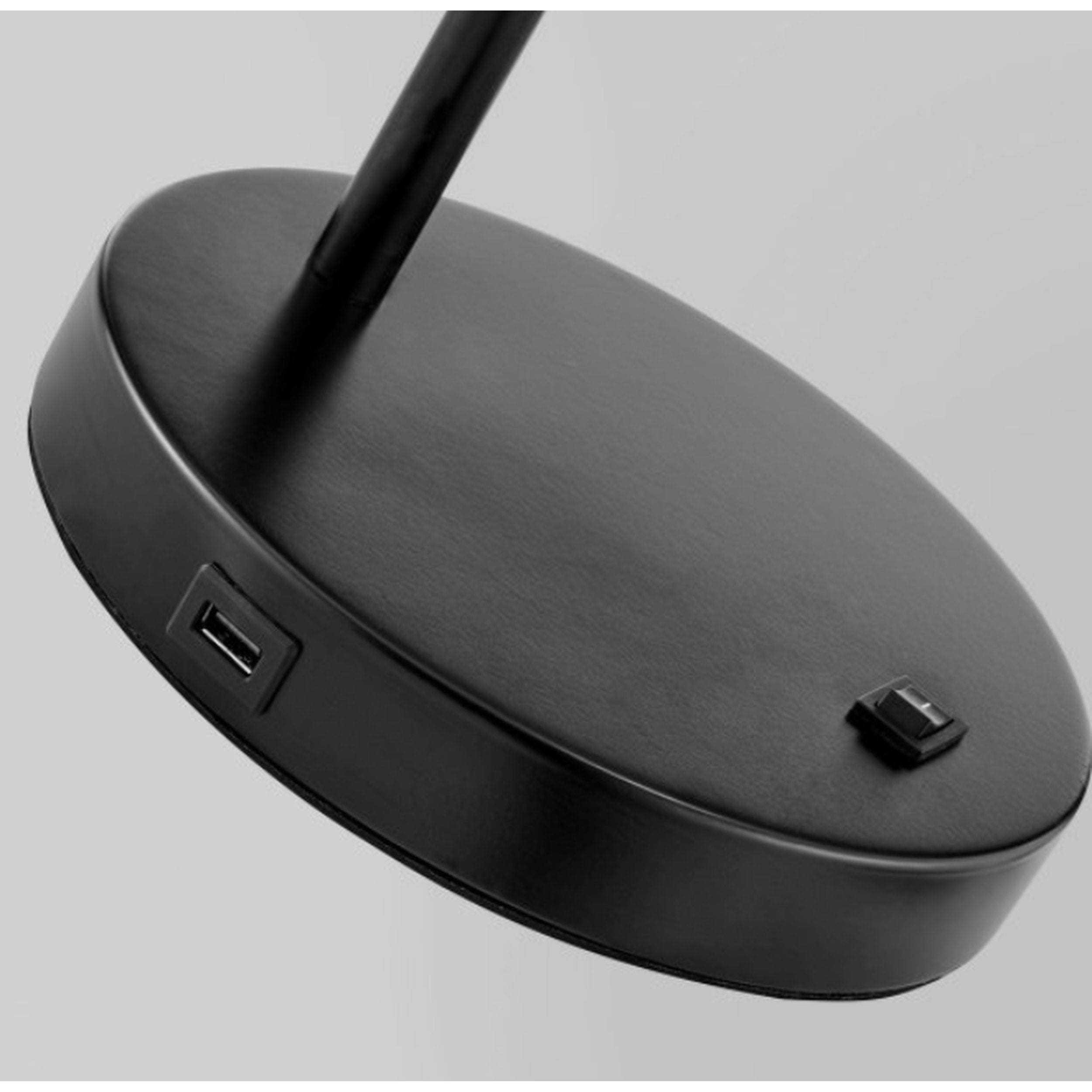 Black desk lamp with USB port on a gray background