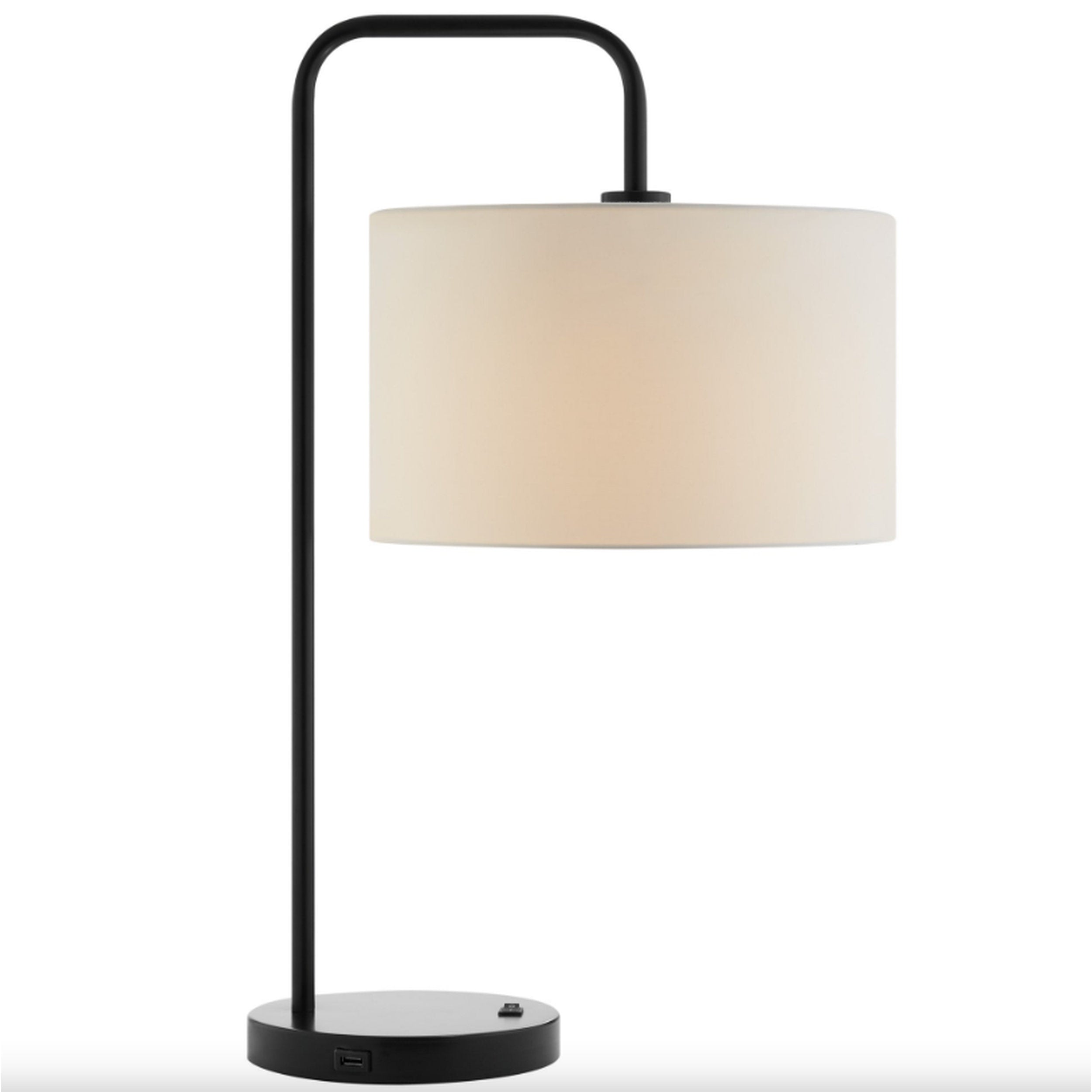 Table lamp with a black curved arm and beige shade on a white background