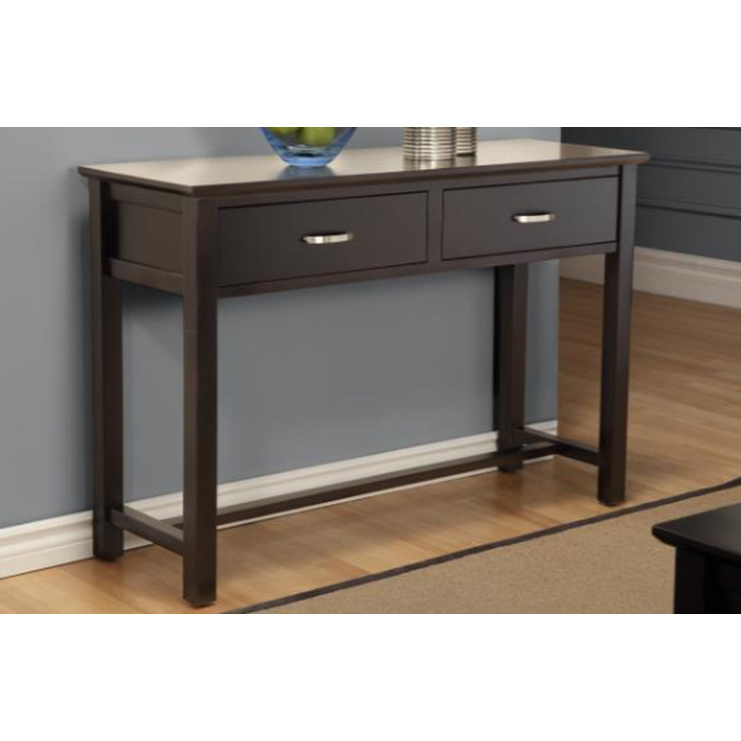 Dark wood console table with two drawers against a gray wall.