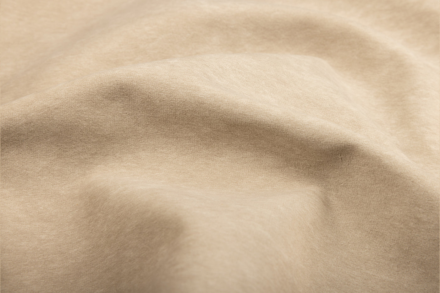 Stewart Oat fabric swatch in warm beige cotton-linen blend, soft tan texture, subtle folds, Van Gogh Designs visible. Brand